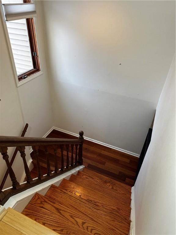 stairway featuring hardwood / wood-style floors