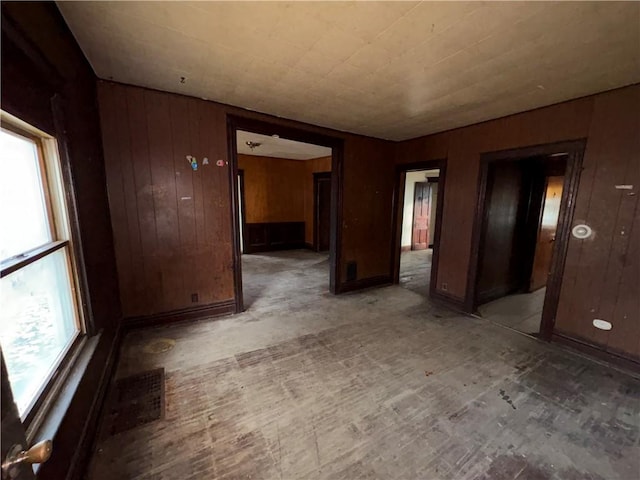 empty room featuring wood walls