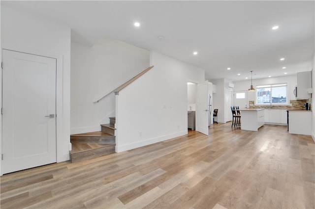 unfurnished living room with light wood-type flooring