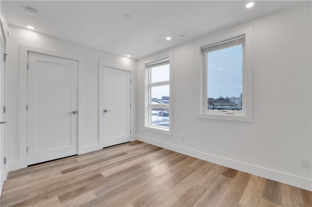 unfurnished bedroom with light wood-type flooring