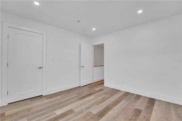 spare room with light hardwood / wood-style flooring