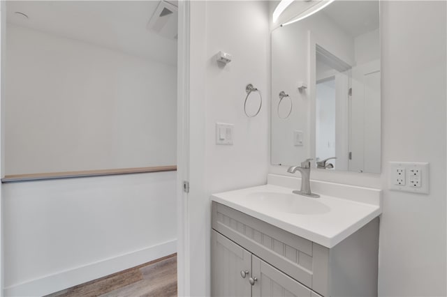 bathroom with hardwood / wood-style floors and vanity