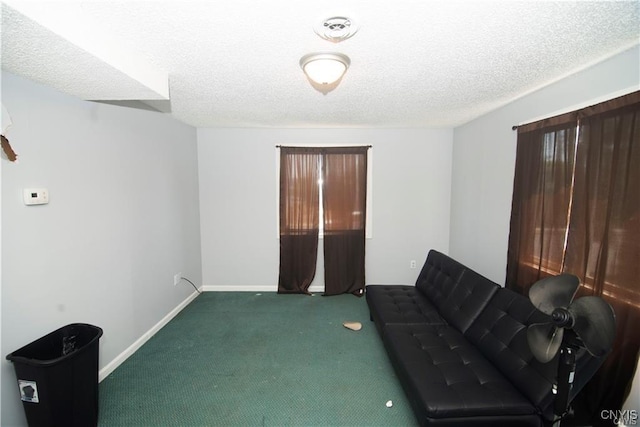 carpeted living room featuring a textured ceiling