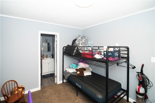 carpeted bedroom with crown molding and ensuite bath