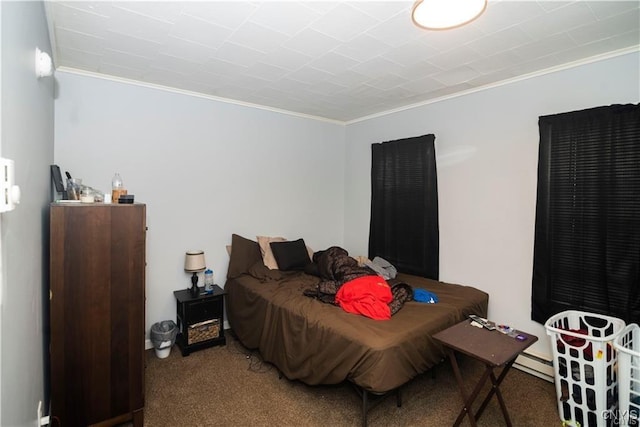 carpeted bedroom featuring baseboard heating and crown molding