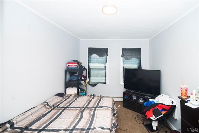 carpeted bedroom with ornamental molding and a baseboard heating unit