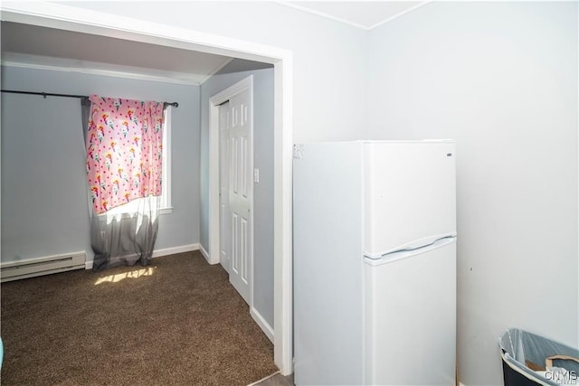 interior space with baseboard heating, a closet, carpet, and white refrigerator