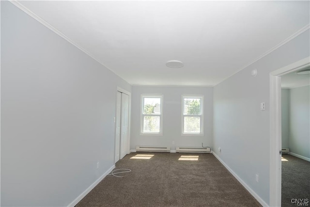 carpeted empty room featuring baseboard heating