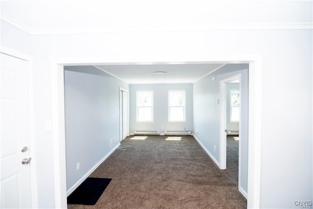 empty room with baseboard heating and dark carpet