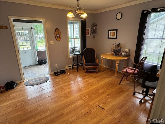 living area featuring ornamental molding, a chandelier, a baseboard heating unit, and light wood-type flooring