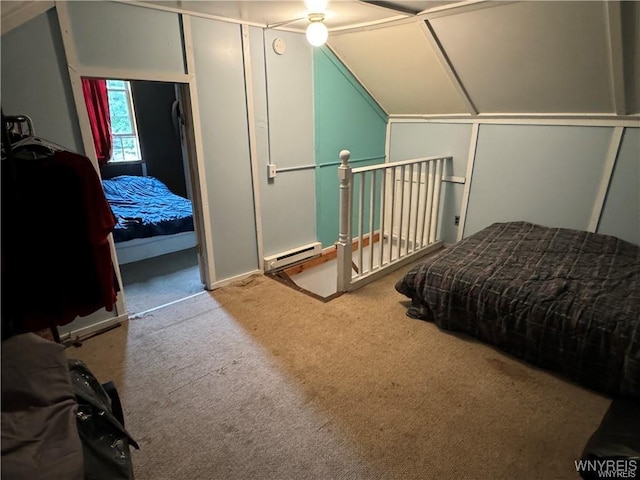 carpeted bedroom with lofted ceiling and a baseboard heating unit