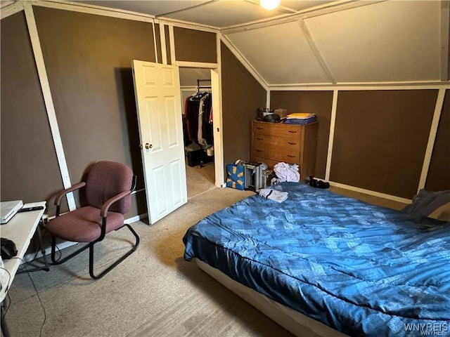 bedroom with carpet, a closet, and lofted ceiling