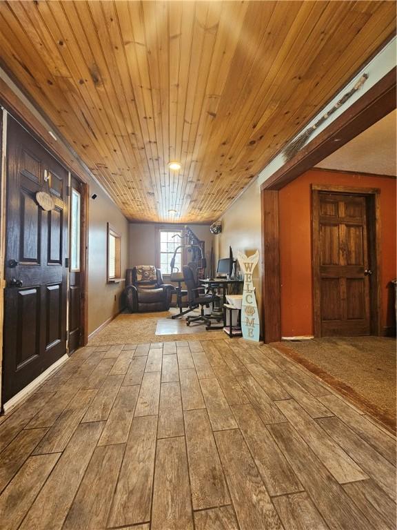 interior space featuring light wood-type flooring and wood ceiling