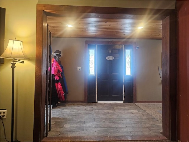 foyer entrance featuring hardwood / wood-style floors and wooden ceiling