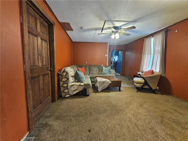 carpeted living room with ceiling fan and a textured ceiling