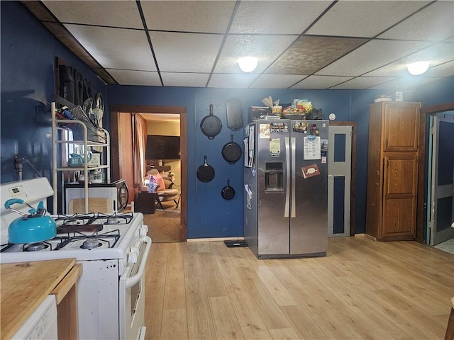 kitchen with light hardwood / wood-style flooring, a drop ceiling, and white appliances