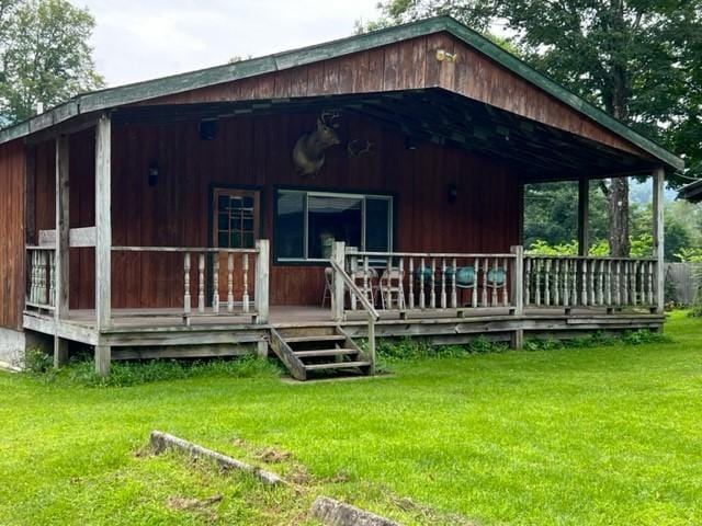 view of outdoor structure with a yard and covered porch