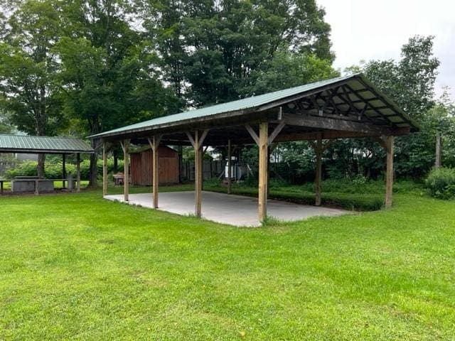 view of community featuring a gazebo, a storage unit, and a lawn