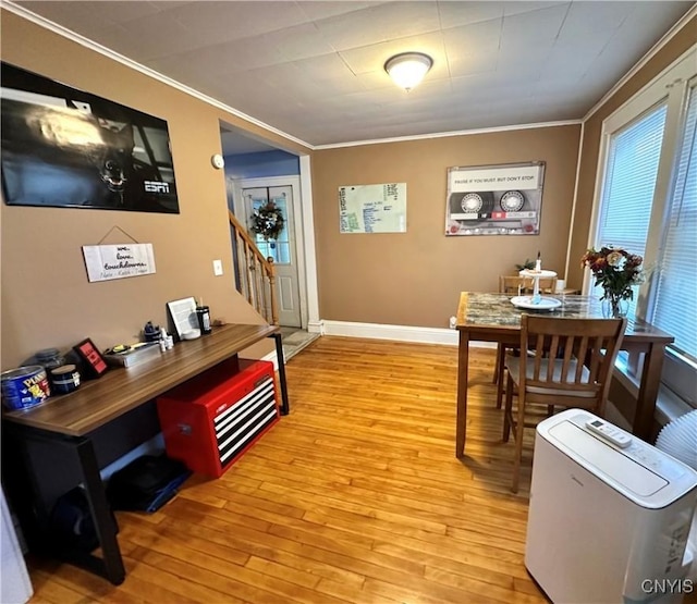 office with light hardwood / wood-style flooring and ornamental molding