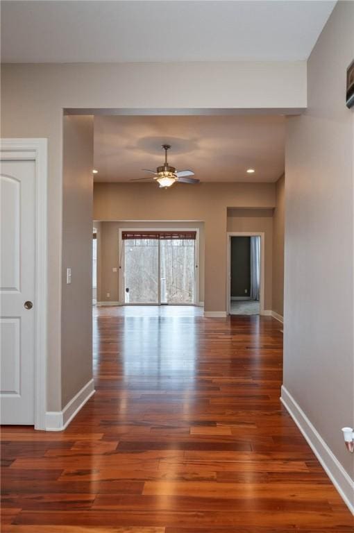 interior space with ceiling fan and dark wood-type flooring