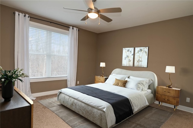 bedroom with carpet, ceiling fan, and multiple windows