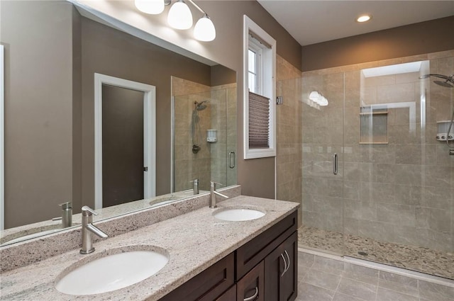 bathroom featuring tile patterned flooring, vanity, and an enclosed shower