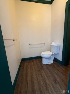 bathroom featuring toilet and wood-type flooring