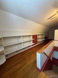 bonus room with dark hardwood / wood-style flooring and vaulted ceiling