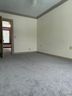 unfurnished room featuring ceiling fan and crown molding