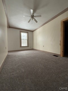 carpeted spare room with ceiling fan and ornamental molding