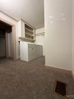 laundry room featuring separate washer and dryer, dark carpet, and crown molding