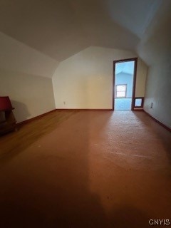 additional living space featuring lofted ceiling