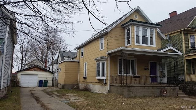 view of front of home featuring an outbuilding, a garage, and covered porch