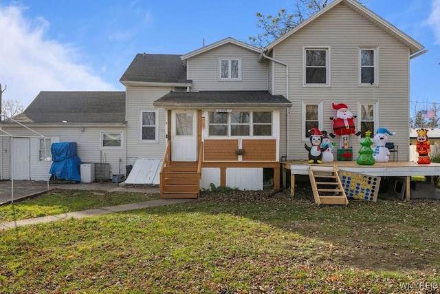 rear view of property with a lawn