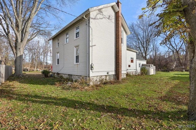 view of side of home featuring a lawn