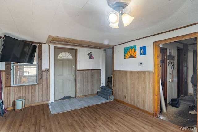 entryway featuring hardwood / wood-style flooring and wood walls