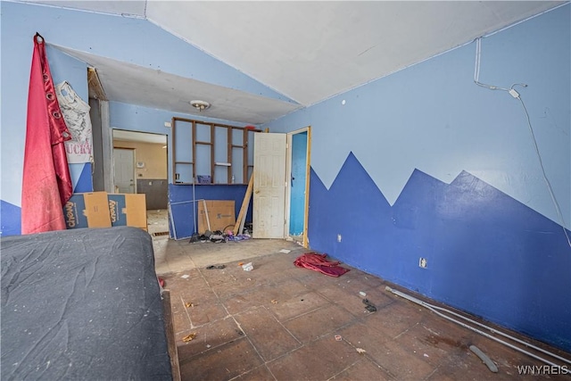 unfurnished bedroom featuring vaulted ceiling