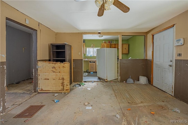 interior space with ceiling fan