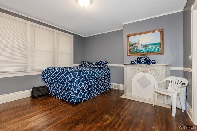 bedroom with dark hardwood / wood-style flooring and ornamental molding