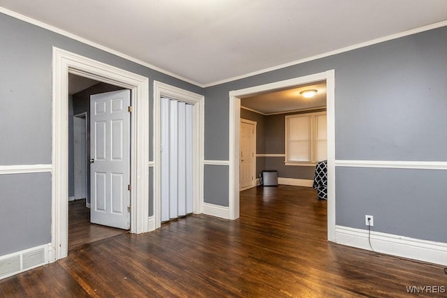 spare room with crown molding and dark hardwood / wood-style floors