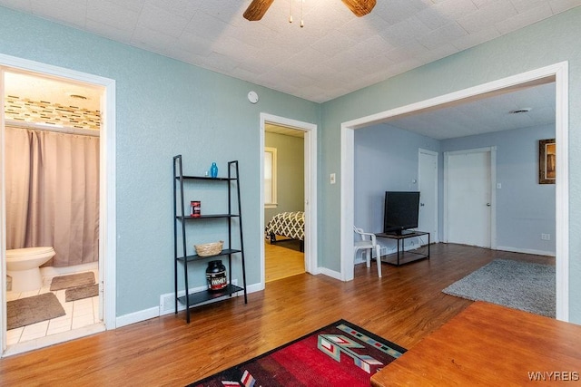 living room with wood-type flooring and ceiling fan