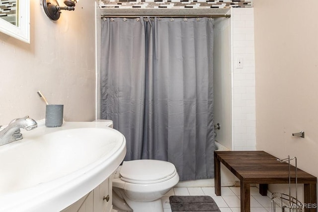 bathroom with tile patterned flooring, a shower with curtain, toilet, and sink