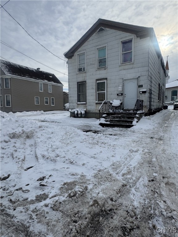 view of snow covered rear of property