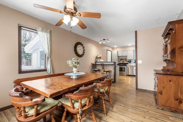 dining space featuring ceiling fan and light hardwood / wood-style floors