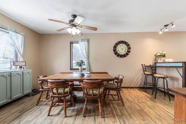 dining space featuring ceiling fan, light hardwood / wood-style floors, and track lighting