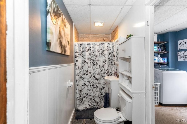 bathroom featuring a drop ceiling and toilet