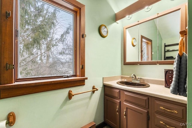 bathroom featuring vanity, plenty of natural light, and lofted ceiling