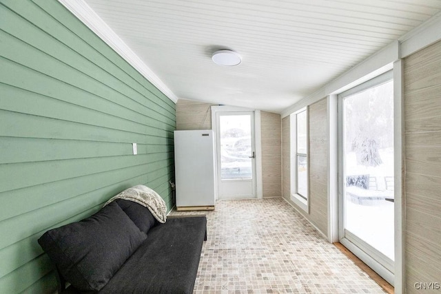 sunroom / solarium featuring vaulted ceiling