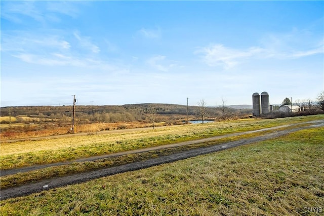 view of yard with a rural view