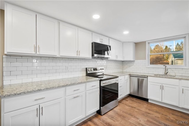 kitchen featuring white cabinets, stainless steel appliances, and sink